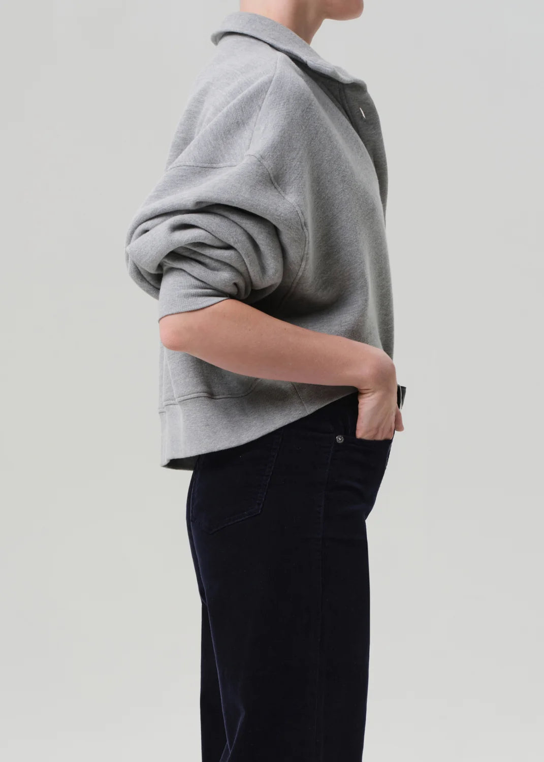 Heather grey Mirelle Funnel Feck sweater by Citizens Of Humanity/AGOLDE, styled with one hand in pocket, side view.
