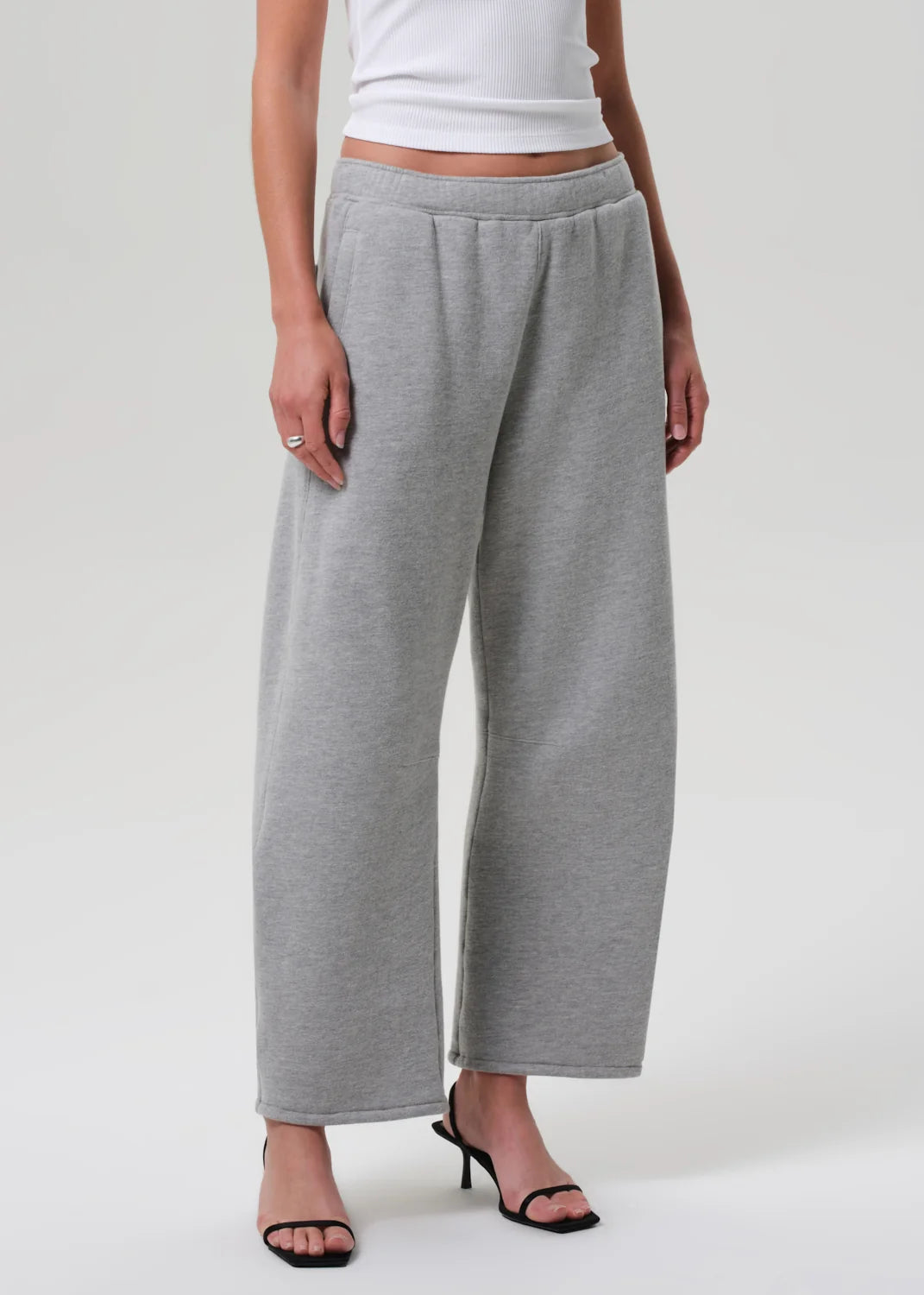 Heather grey Miro Sweatpant by Citizens Of Humanity/AGOLDE styled with a white top and black heeled sandals.