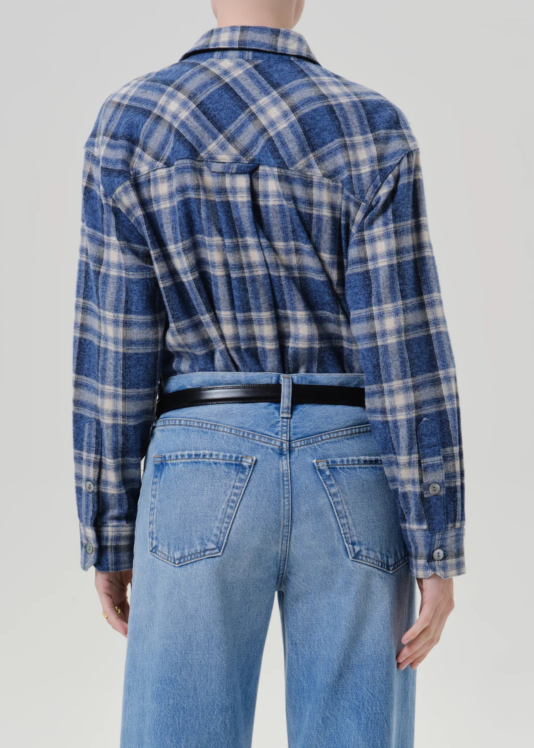 Back view of vintage plaid button-up shirt in blue marina by Citizens of Humanity against a plain background.