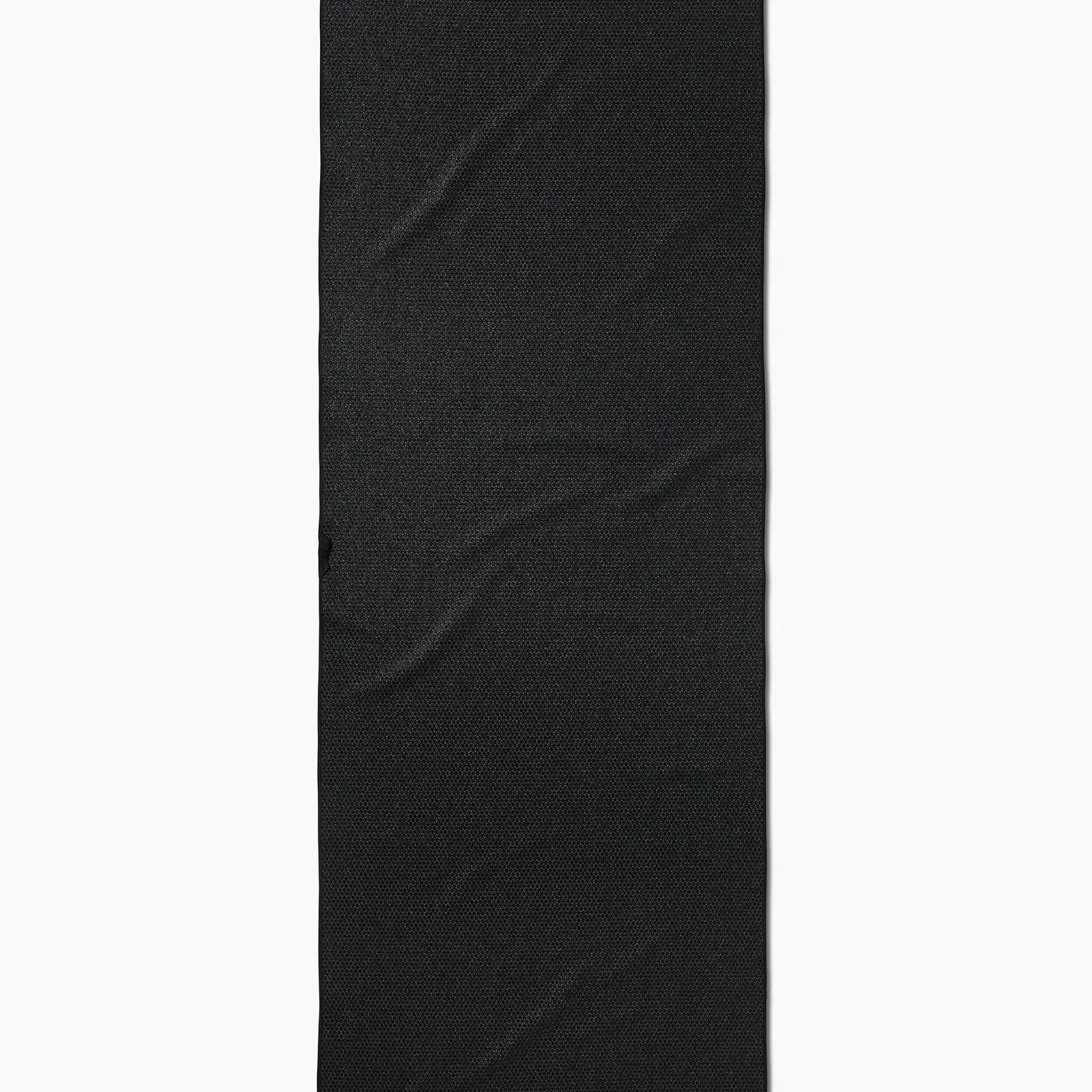 The Faire Leopard Yoga Towel, an ultra-absorbent black towel with a subtle textured pattern and visible wrinkles, is shown vertically against a white background.