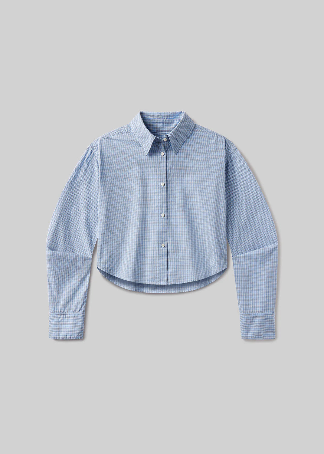 The ana cropped shirt in banker blue plaid by Citizens Of Humanity/AGOLDE features a light blue and white check pattern, button-up front, long sleeves, and pointed collar. Shown against a plain gray background.