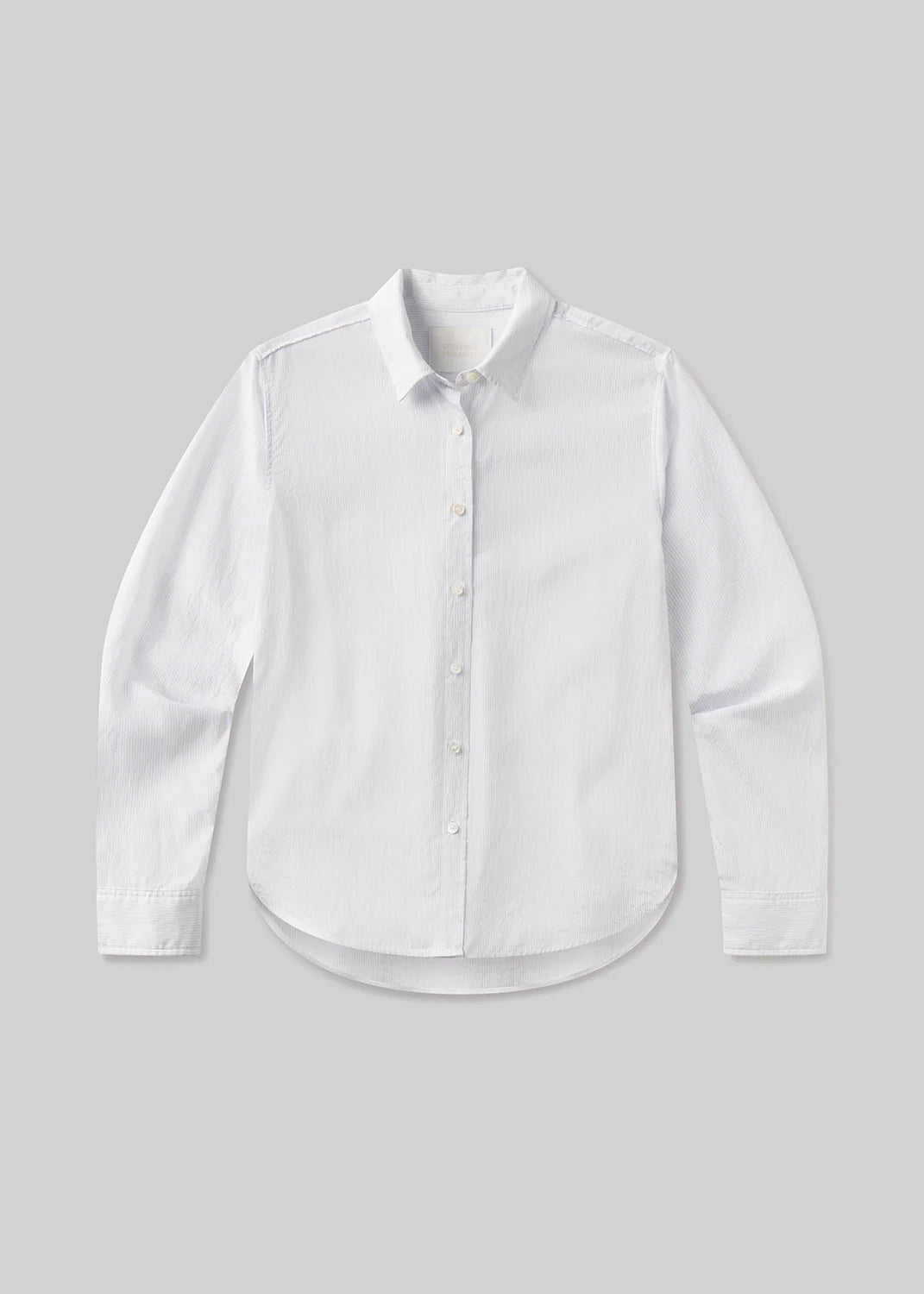 The avni slim shirt in blue micro stripe by Citizens Of Humanity/AGOLDE is a long-sleeve tailored women’s shirt with a collar and curved hem, laid flat on a light gray background, crafted from lightweight Italian shirting.