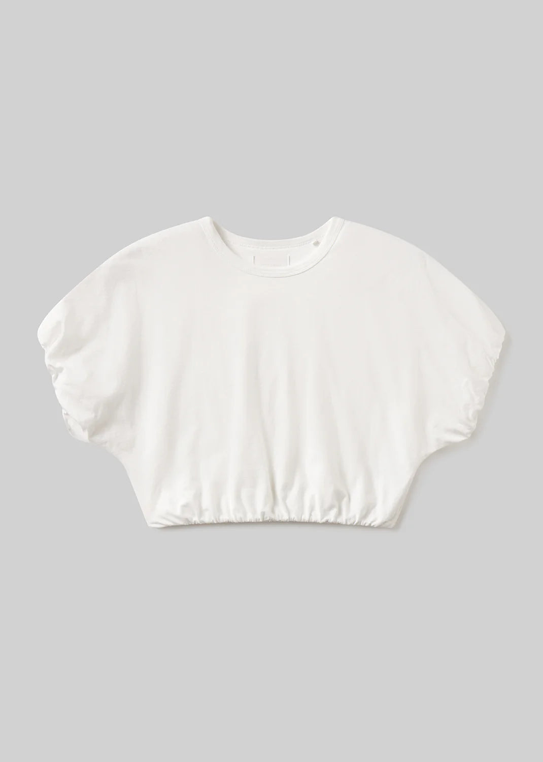 The gia bubble tee by Citizens Of Humanity/AGOLDE is a white, short-sleeve cropped top with a loose fit and elasticated hem, shown on a plain light gray background.