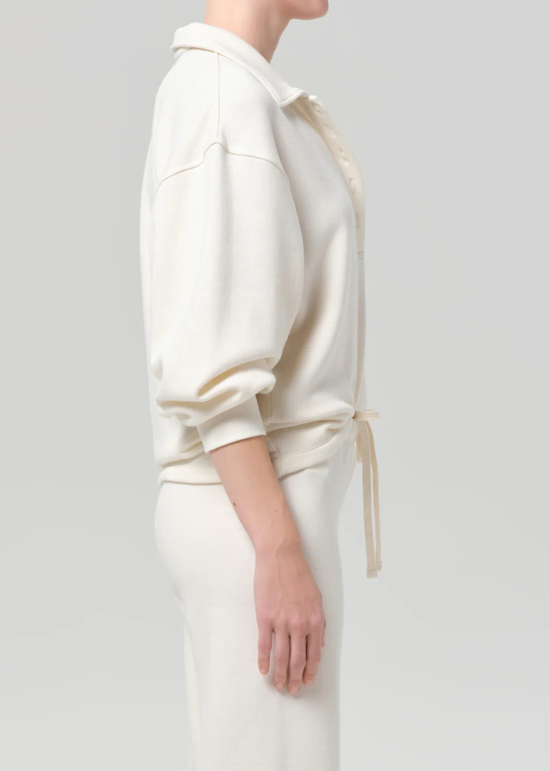 Vintage cream polo and matching pants by Citizens Of Humanity/AGOLDE, modeled against a light grey backdrop.