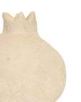 A close-up of the Turner Pomegranate by Faire, a beige ceramic ornament with a textured surface and crown-shaped top, ideal for rustic home decor, set against a plain white background.