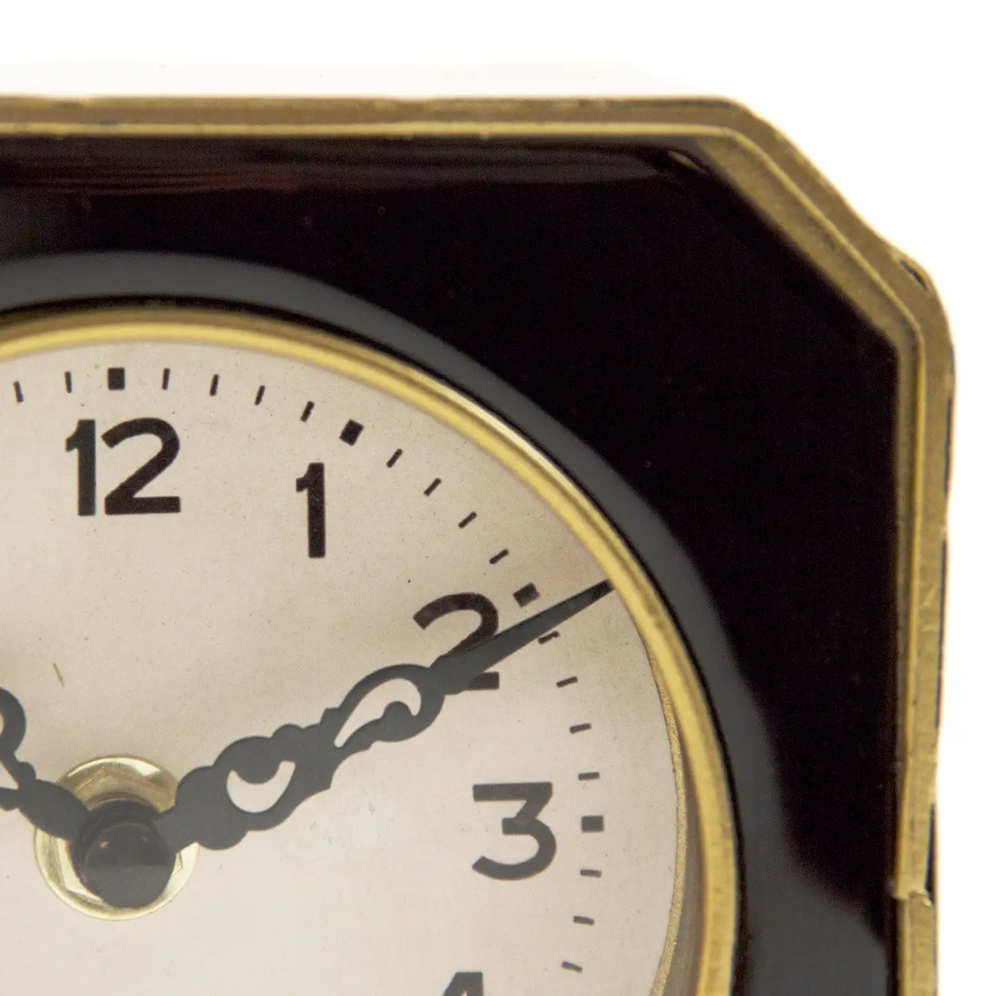 Close-up of the Zentique Black and Gold Clock, a vintage-style octagonal table clock with white dial, black hour marks, and gold accents. Its dark, angular border makes it a striking piece for elegant décor. Shows time at 10:10.