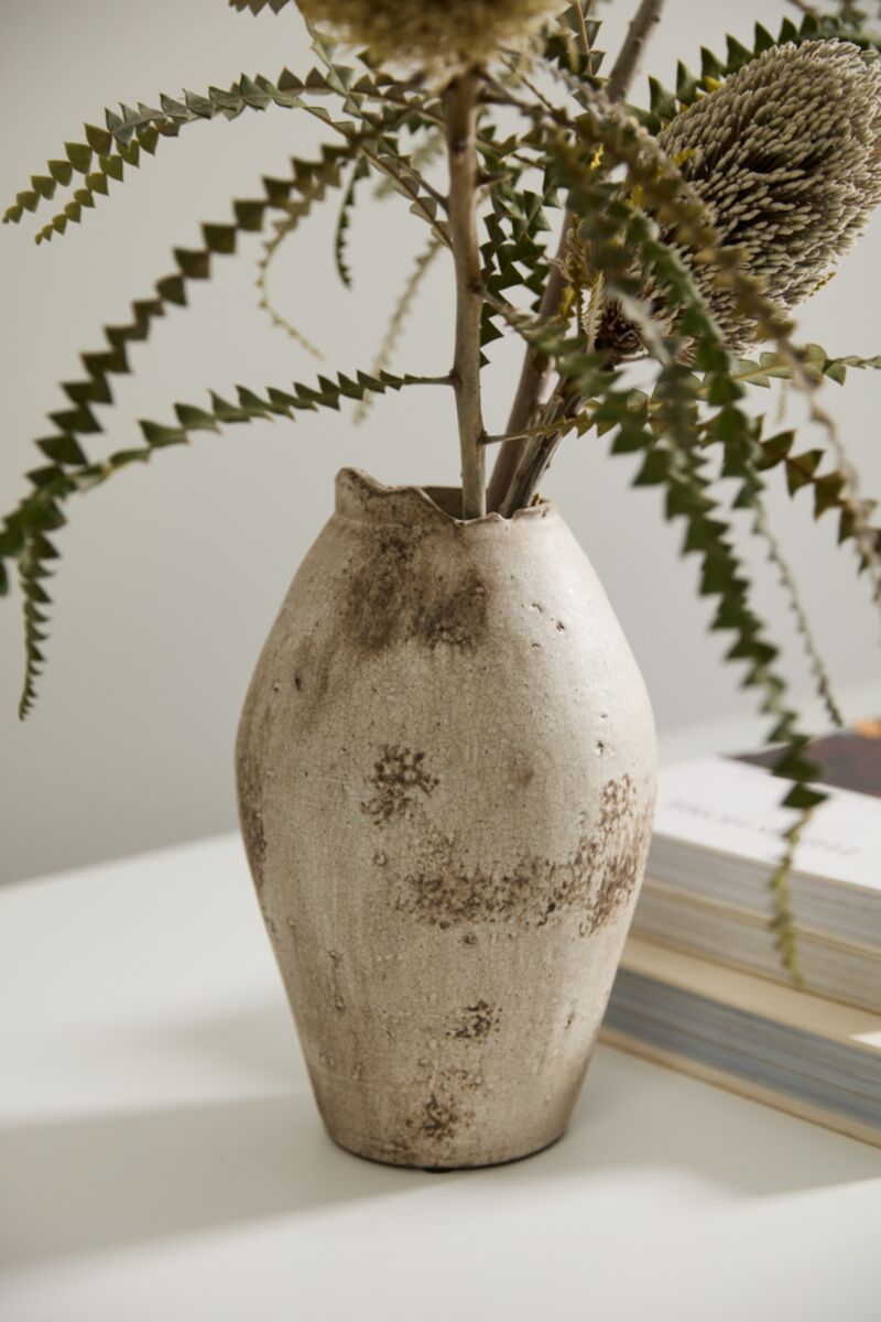 Danez Vase by Accent Decor with dried flowers beside books on a white surface for a cozy, rustic look.