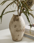 Danez Vase by Accent Decor with dried flowers beside books on a white surface for a cozy, rustic look.