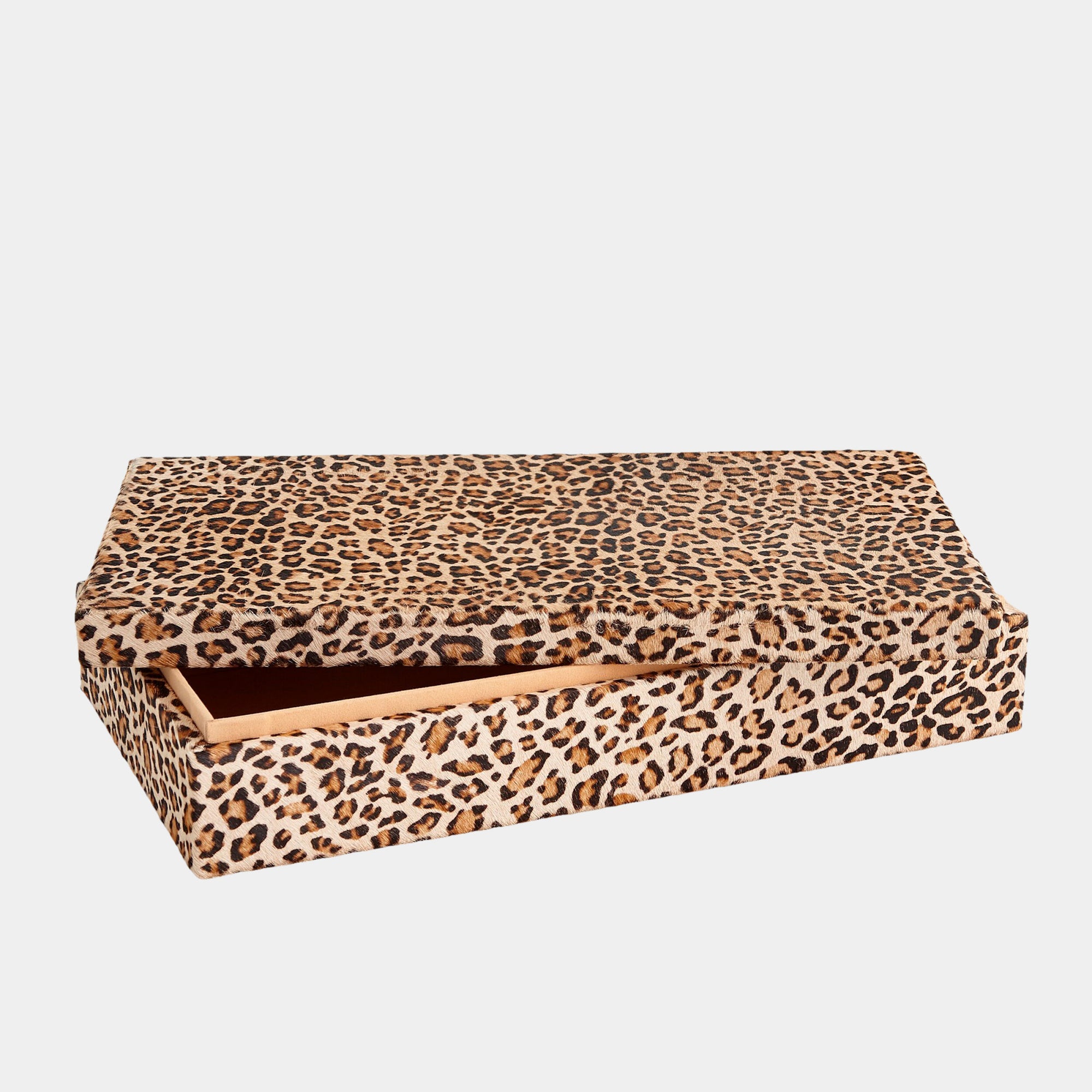 The Global Views Cheetah Box L features a bold cheetah print and a hinged lid, partially open to display its plain faux suede interior, set against a simple light background.