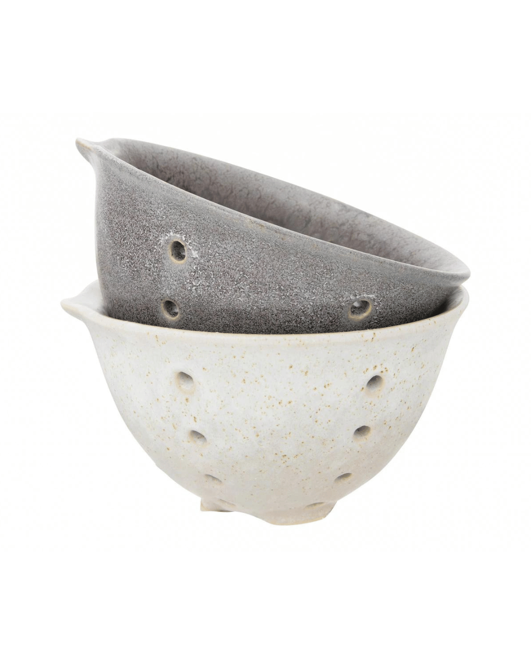 Two Creative Co-op Berry Bowls are shown stacked together, reminiscent of stoneware berry baskets. The top bowl boasts a dark gray speckled finish with a reactive glaze, while the bottom features a light beige speckled look. Both offer a simple, rustic design with circular drainage holes and small spouts on their rims—perfect for preparing healthy snacks.