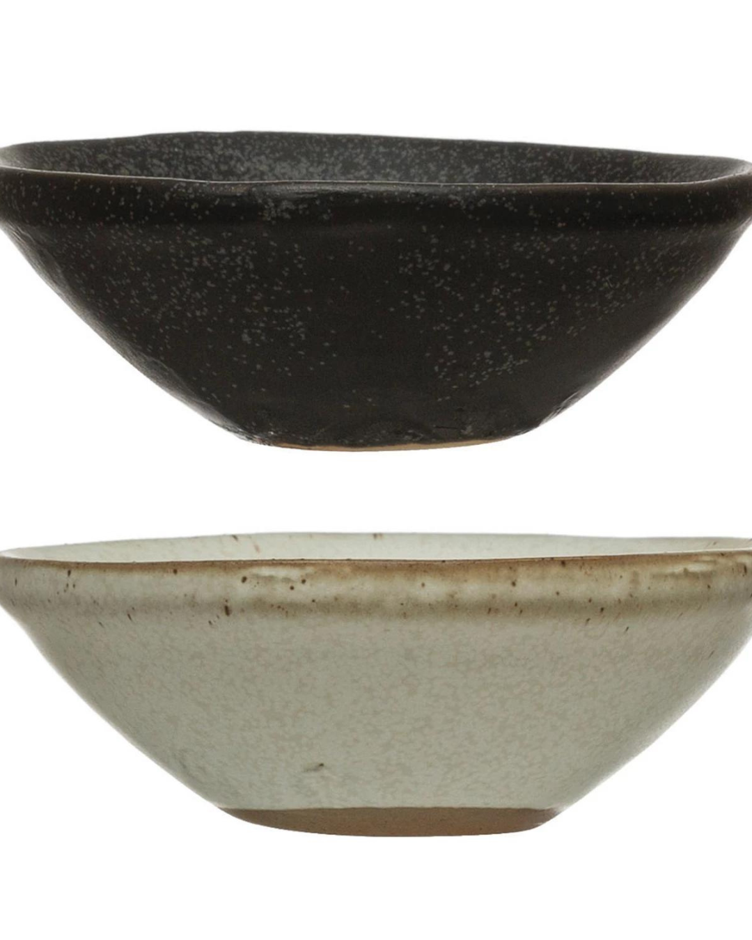 Two Mini Bowls by Creative Co-op, each measuring 3-1/2" in diameter, are stacked vertically. The top bowl showcases a black matte reactive glaze with a speckled texture, while the bottom bowl is white with subtle speckling and a slightly visible natural clay color at the base. Both bowls feature a simple, rustic design.