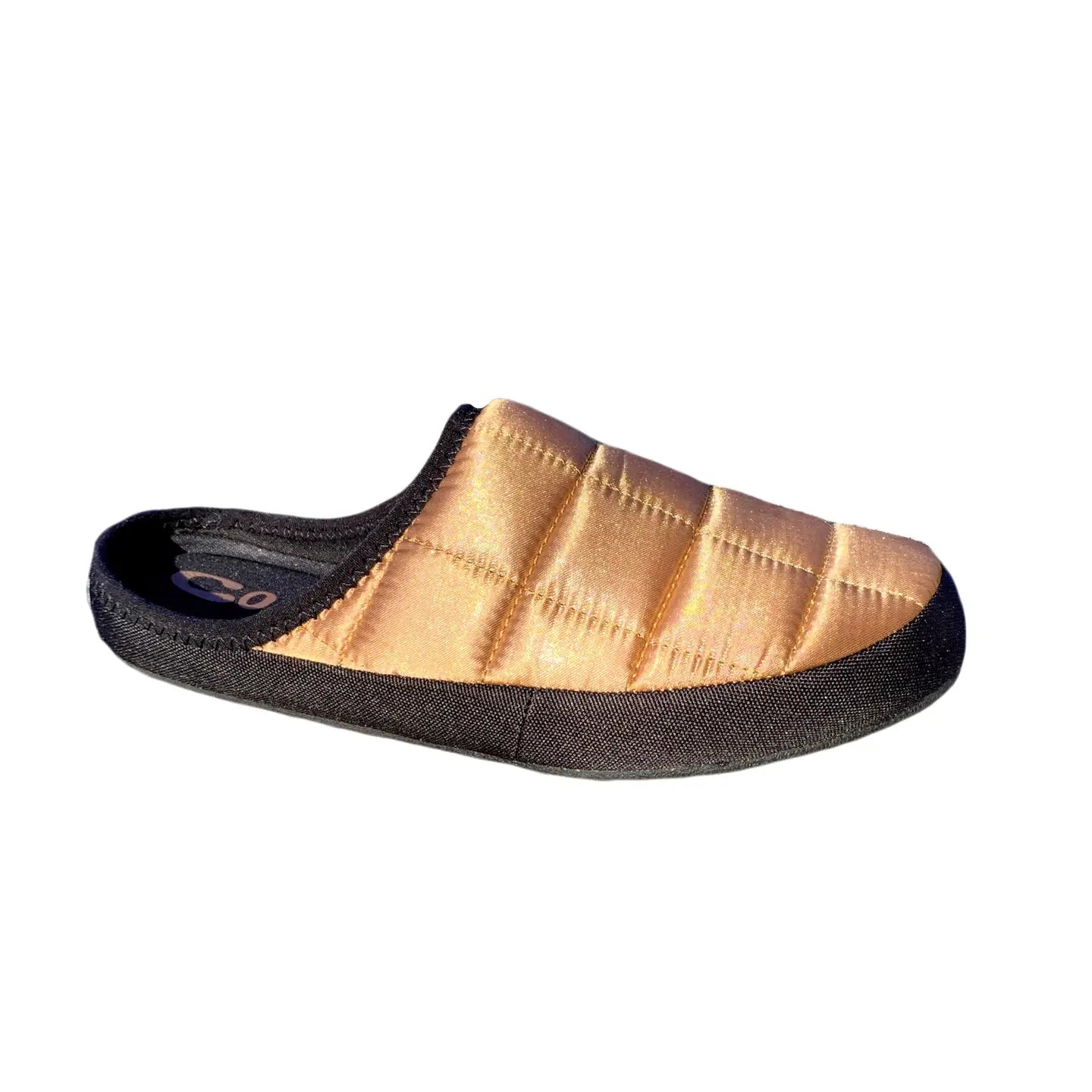 The Faire Coma Toes is a golden-brown, quilted slip-on lounge slipper with a black sole and trim, shown in a side view against a white background.