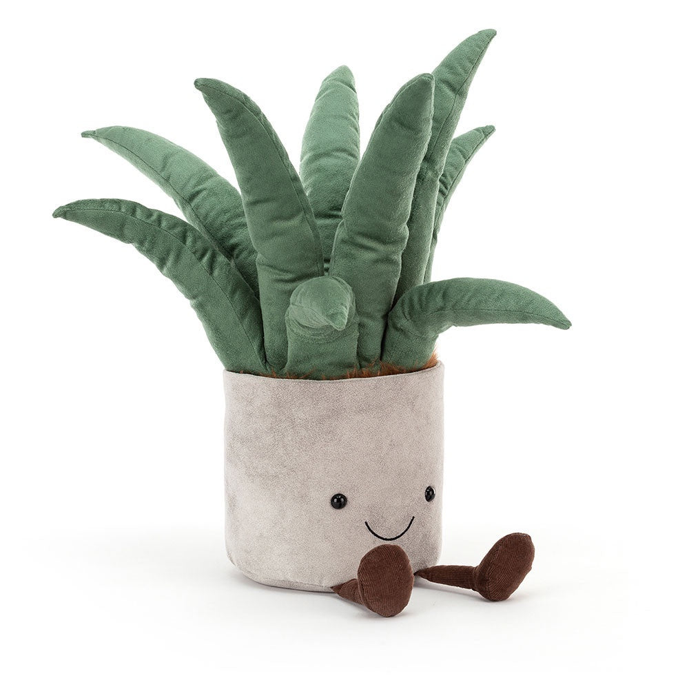 The Big Potted Plant Aloe by Jelly Cat Inc. is a plush toy crafted to resemble an aloe plant in a pot, complete with a cheerful face. Its long, green leaves contribute to its delightful appearance, and the beige pot featuring tiny brown legs adds extra charm. With its simple and happy expression, this potted plant toy is perfect for brightening up any room.