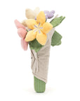The Bouquet of Flowers by Jelly Cat Inc. features soft pastel blooms in yellow, pink, and lavender, arranged in a light beige cloth with a button—making it a charming gift.