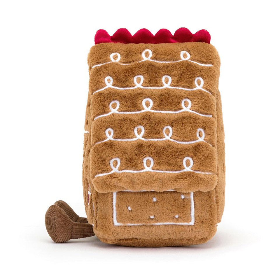 The Amuseables Gingerbread House by Jelly Cat Inc. is a delightful plush shaped like a festive gingerbread house, perfect for cozy holiday décor or as a charming gift.