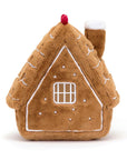 The Amuseables Gingerbread House by Jelly Cat Inc. is a plush toy featuring white icing, a square window, a red dot on top, and a soft chimney on the right side.