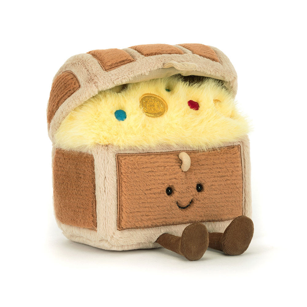 The Jelly Cat Inc. Treasure Chest is a plush toy featuring a smiling face, brown legs, and yellow fluffy “gold” inside, plus a plush coin and colorful gems—perfect for imaginative high seas treasure hunts.