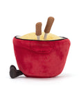 The Amuseables Cheese Fondue by Jelly Cat Inc. is a plush toy shaped like a red pot with yellow "cheese," brown chopsticks, and a black handle—perfect for adding Swiss-inspired fun to dinner parties.