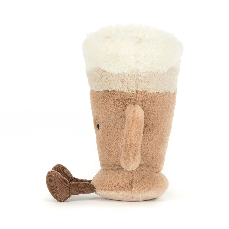 The Amuseables Latte plush toy by Jelly Cat Inc. features a beige mug design with a handle, fluffy white "latte art" top, and soft brown feet—perfect for cozy fun.
