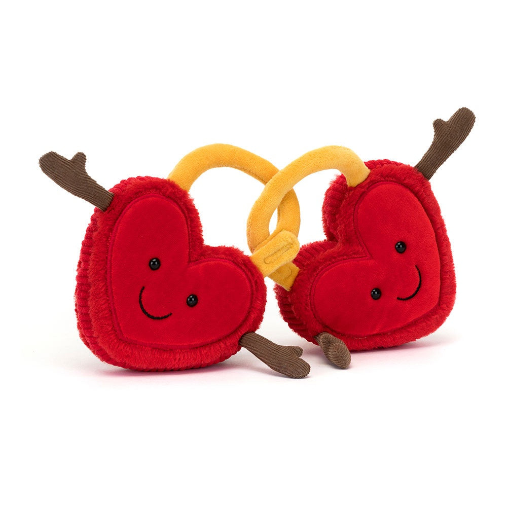 The Amuseables Val & Tina by Jelly Cat Inc. are two plush, heart-shaped toys with cheerful faces and brown antler-like decorations, connected by a detachable yellow band. Made from soft red fur, they stand out brilliantly against the plain white background.