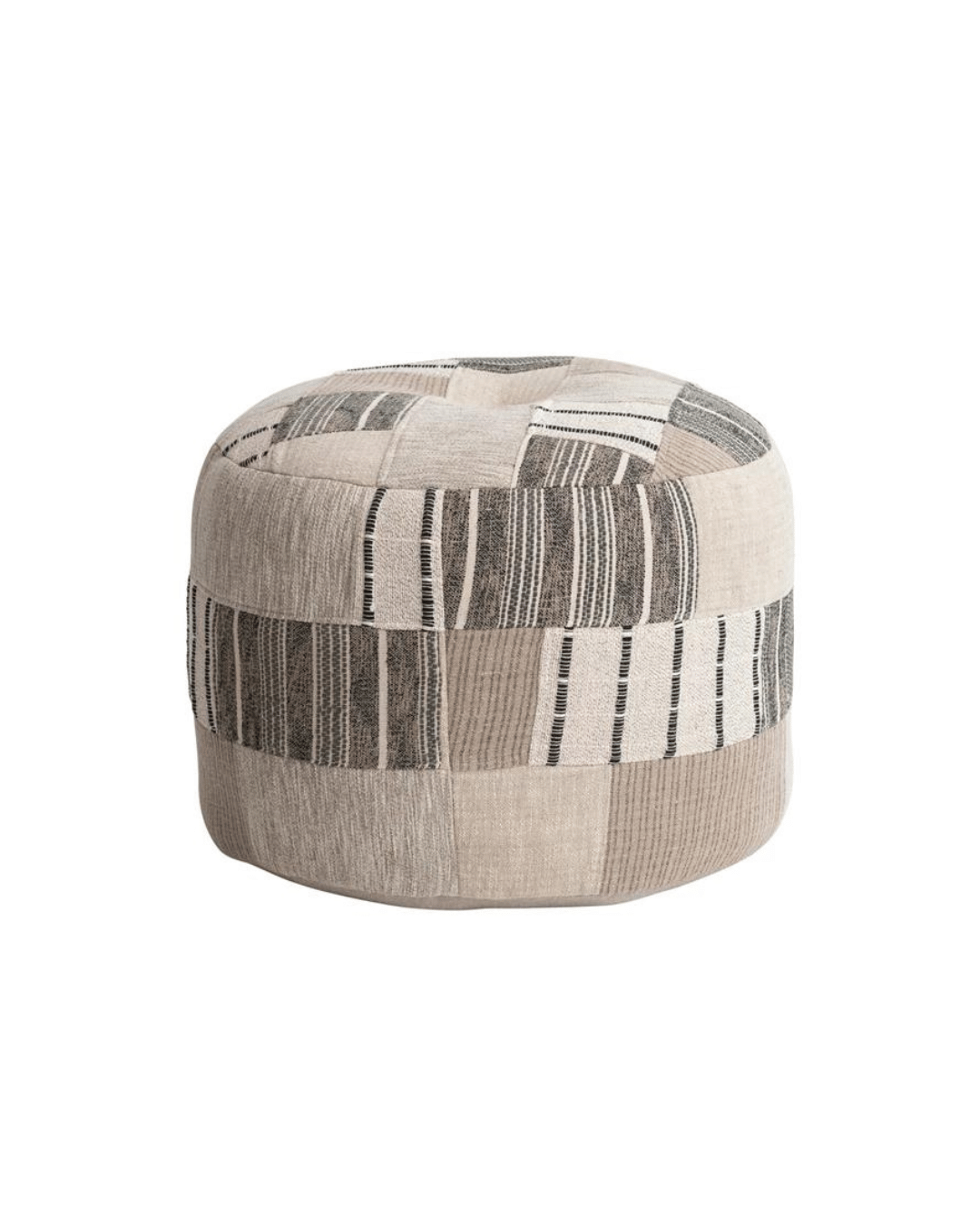 A round beige Slub Patchwork Pouf, Neutral 24" Round x 18"H by Creative Co-op with a patchwork design, featuring various geometric patterns in black and white. This pouf exudes artisanal charm with its textured fabric and contemporary look, suitable for seating or as a decorative accent in a living space.