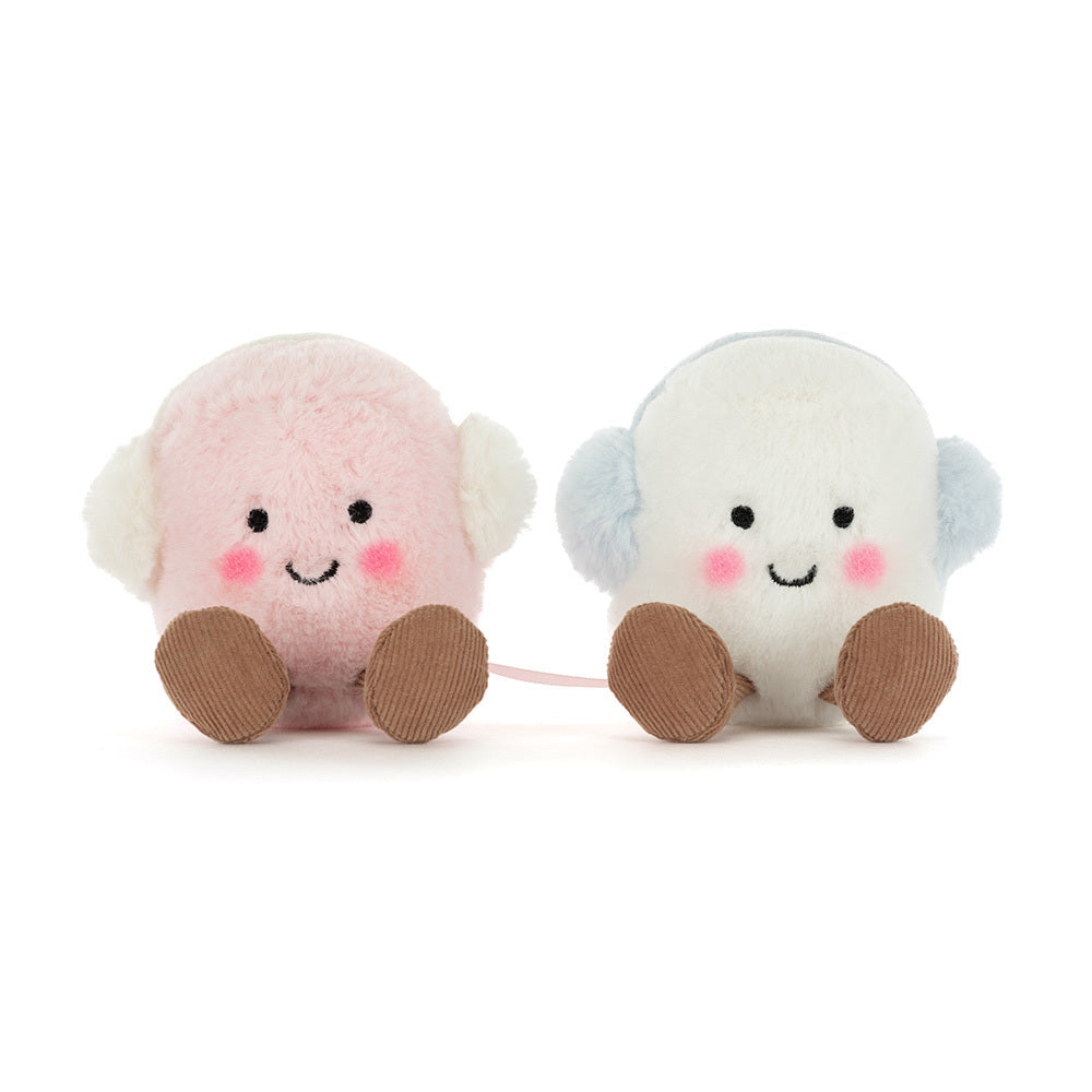 Two Amuseables Toastie Pink and White Marshmallows by Jelly Cat Inc.—adorable round plush toys with smiling faces, blushing cheeks, brown feet, and fuzzy earmuffs—make a perfect cozy gift for any winter collection.