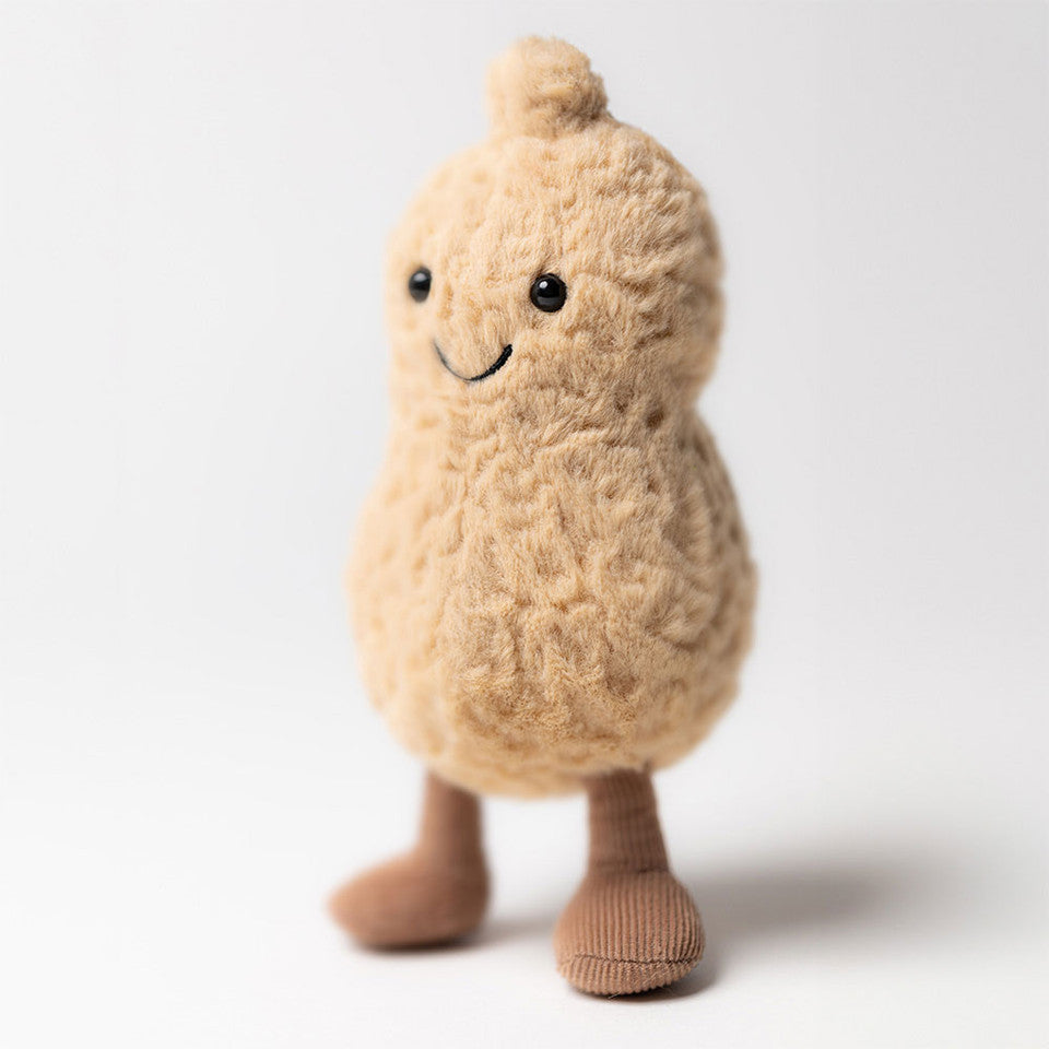 The Amuseable Peanut by Jelly Cat Inc. is a plush toy with a textured tan surface, black eyes, a small smile, and brown legs—ideal for fans or collectible stuffed animal enthusiasts.