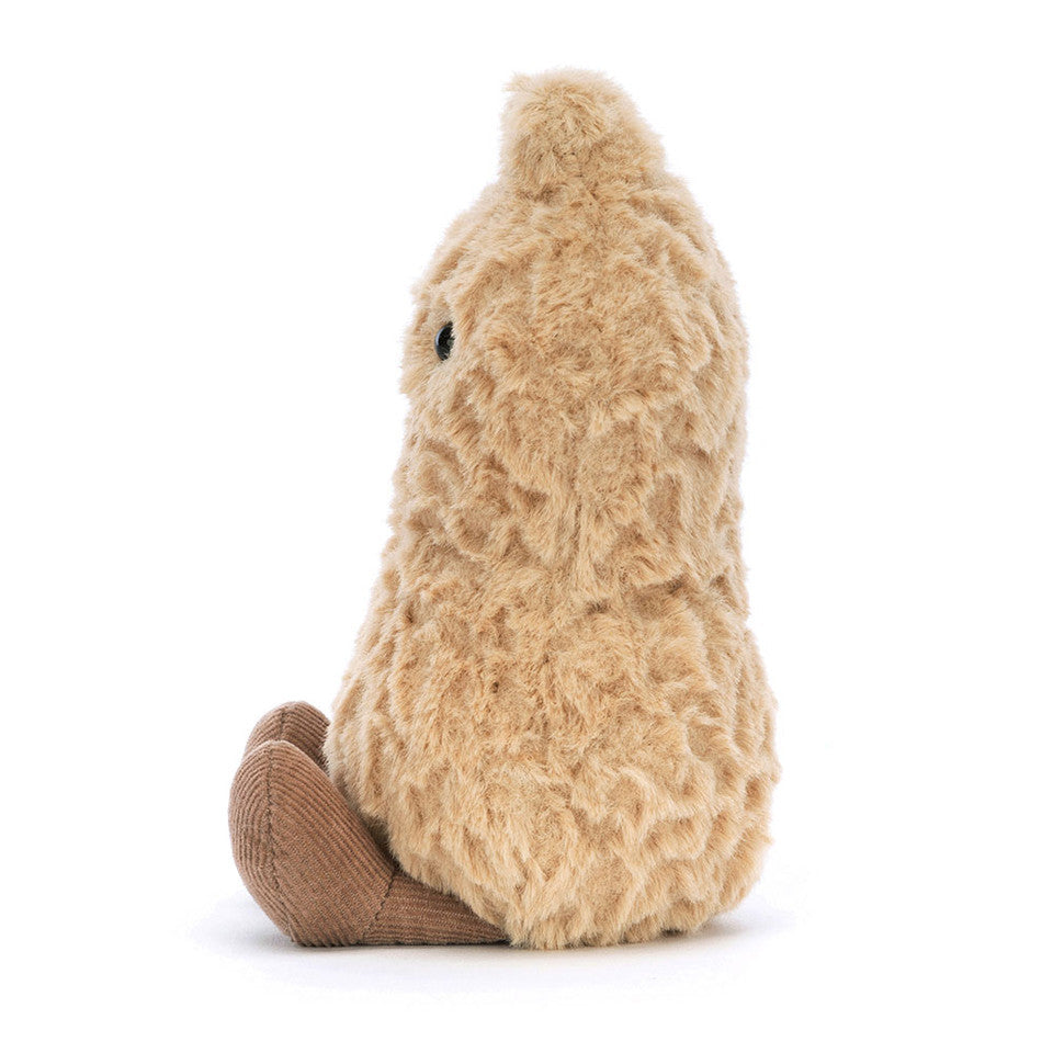 The Jelly Cat Inc. Amuseable Peanut is a fuzzy, light brown plush with a rounded shape and a darker brown base resembling feet. It sits upright, facing left with a small black eye on its side against a white background.