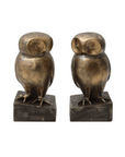 The Resin Owl Bookends by Bloomingville feature two bronze sculptures of owls, ideal for use as elegant bookends. Each statue perches on a square base with a smooth finish and has minimal facial features, positioned to face slightly toward each other.