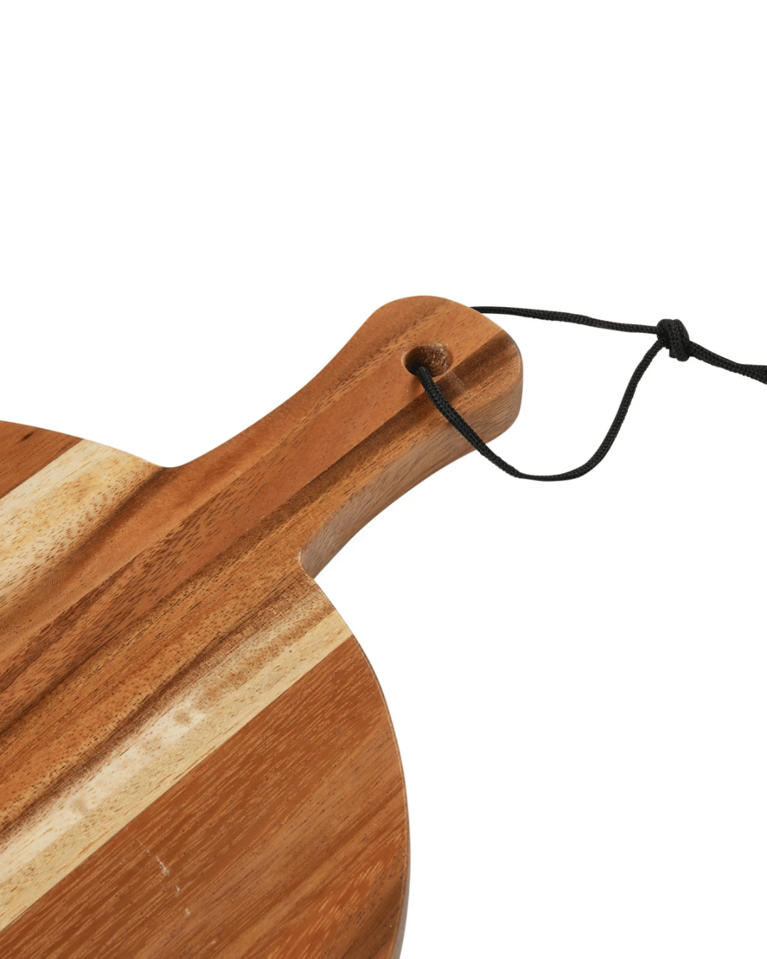 Close-up of the Creative Co-op Wood Cutting Board, made from eco-friendly suar wood. It features a striking contrast with alternating light and dark stripes and a handle with a black cord for easy hanging.