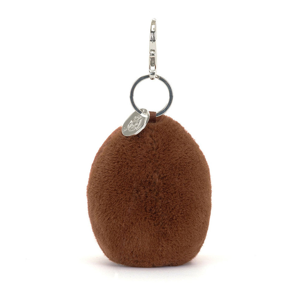 The Amuseables Coffee Bean Bag Charm by Jelly Cat Inc. is a round, brown, fluffy bag accessory with a metal ring, clasp, and a small silver tag—perfect for adding cute style to your bag.