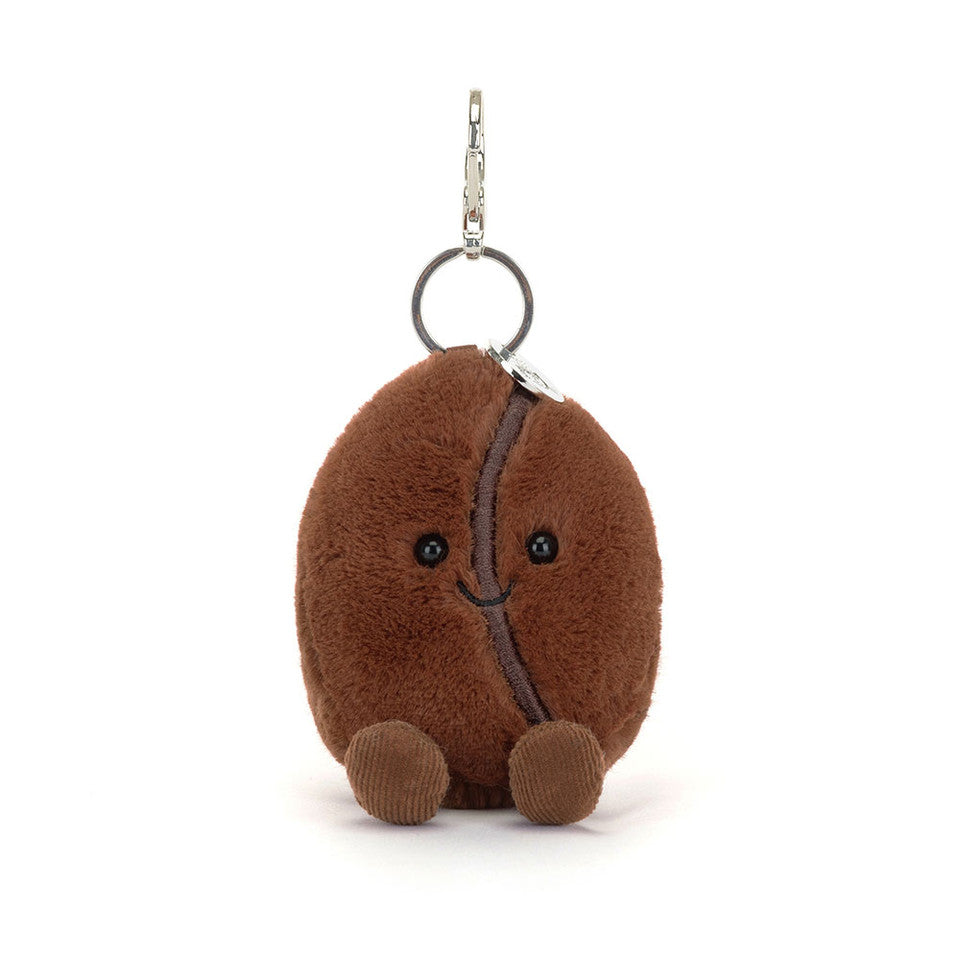 The Jelly Cat Inc. Amuseables Coffee Bean Bag Charm is a plush keychain shaped like a smiling brown coffee bean with round feet—an adorable accessory for your bag.