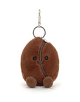The Jelly Cat Inc. Amuseables Coffee Bean Bag Charm is a plush keychain shaped like a smiling brown coffee bean with round feet—an adorable accessory for your bag.