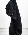A pair of Cashmere/Wool Flap/Snap Pants by Free City (sparrow, LLC), loose-fitting and black with an elastic waistband and cuffs, hangs against a plain white background. The "art commerce" logo is at the bottom left corner.