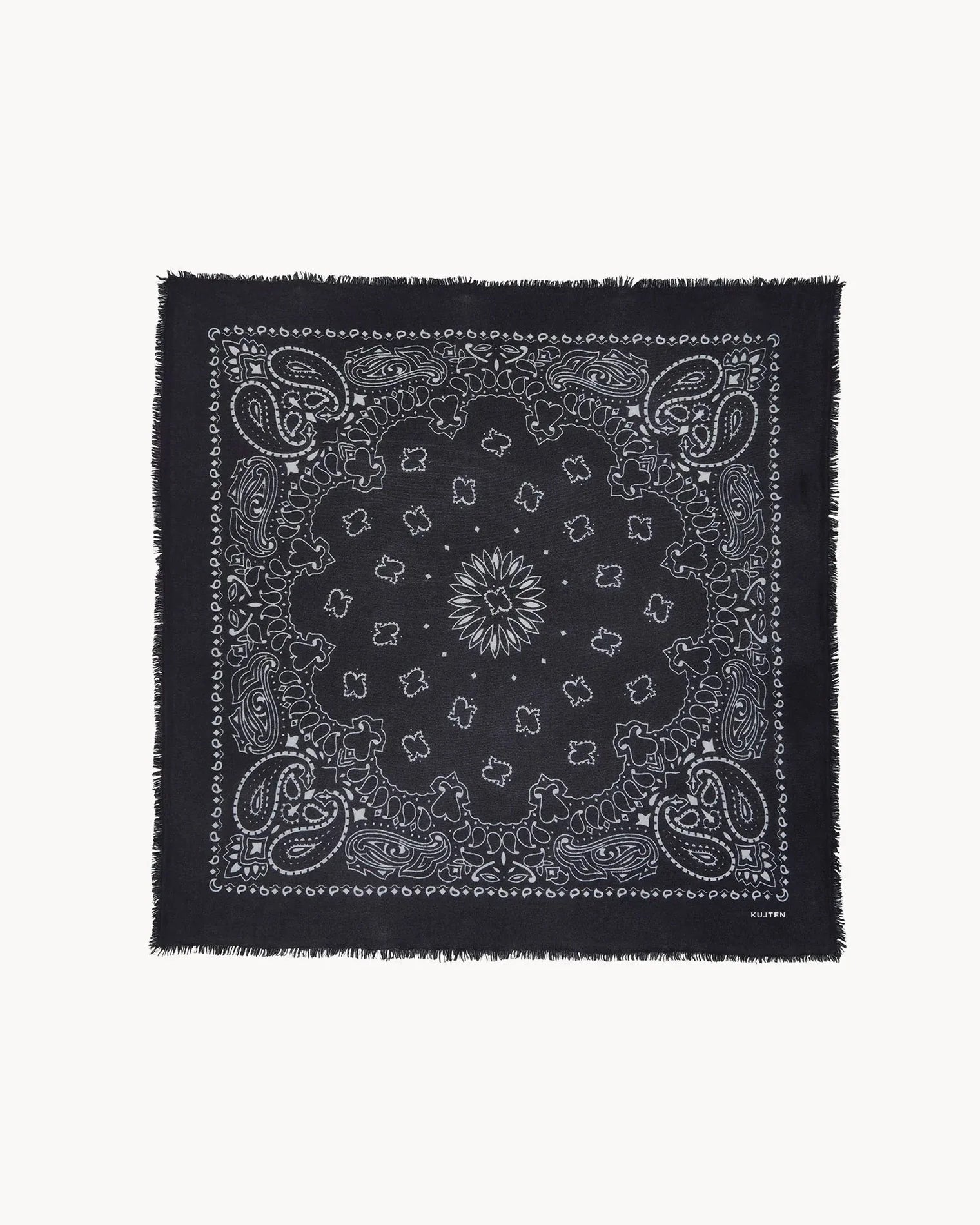Black cashmere scarf with white paisley print and frayed edges by KUJTEN, shown flat on a white background.