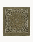 The KUJTEN Hachiko Scarf is a square olive green accessory with a white paisley and floral print, finished with frayed edges.