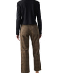 A person stands facing away against a white background, wearing AMO Denim's Lillian Plaid Cord straight-leg pants with a long-sleeve black top and black shoes.