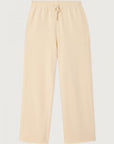 The Atubay Pants by American Vintage are beige wide-leg cotton joggers with an elastic waistband, drawstring, and side pockets, shown laid flat on a white background.