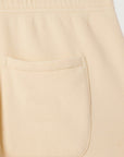 Close-up of the back pocket on Atubay Pants by American Vintage, showcasing the elastic waistband and soft cotton texture in beige.