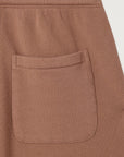 Close-up of the Atubay Short by American Vintage, a brown cotton piece with a single rectangular patch pocket and visible stitching along the soft fabric.