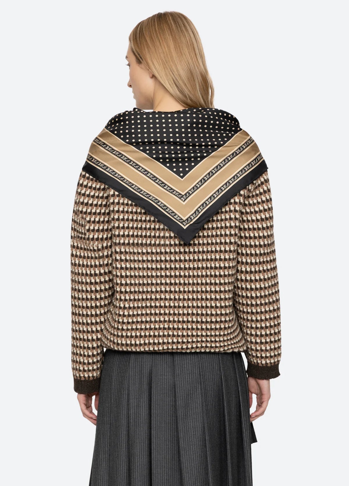 Declan S/Slv Polo Sweater by Sea New York in a soft knit, styled with a pleated skirt and scarf, back view.