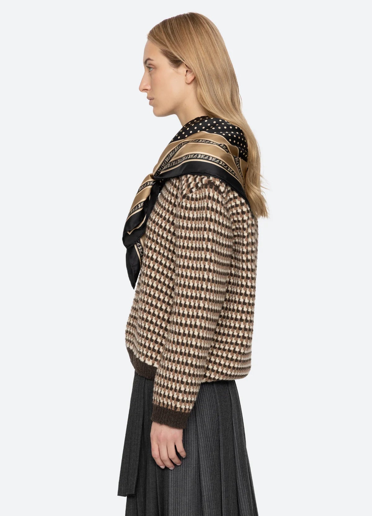 Sea New York DECLAN short-sleeve polo sweater and pleated skirt styled with scarf, shown in profile against plain background.