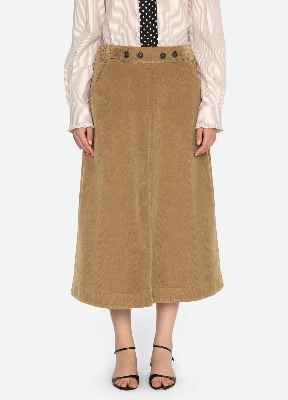 Sea New York Garrett corduroy midi skirt in soft brown, styled with a light shirt and polka dot tie.