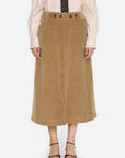 Sea New York Garrett corduroy midi skirt in soft brown, styled with a light shirt and polka dot tie.