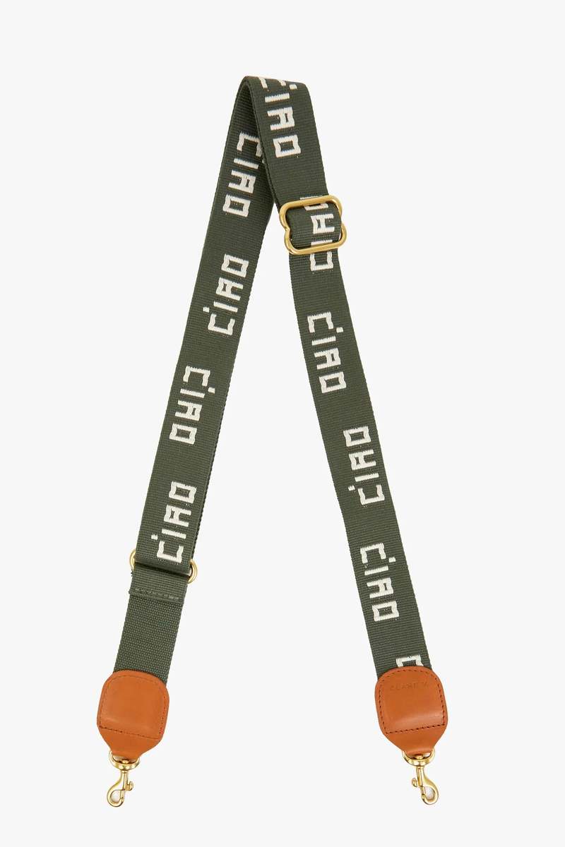 Clare Vivier's Crossbody Strap S25 features green adjustable cotton webbing, gold hardware, and brown leather accents. "Ciao" is repeatedly woven in white—ideal for elevating any favorite crossbody or shoulder bag.