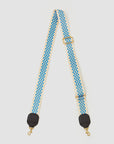 A stylish Clare Vivier Crossbody Strap with a blue and white checkerboard pattern, perfect for your favorite crossbody bag. The strap features black leather ends with gold-tone swivel clasps and an adjustable gold buckle. Made from durable nylon webbing, it ensures both style and longevity on a white background.