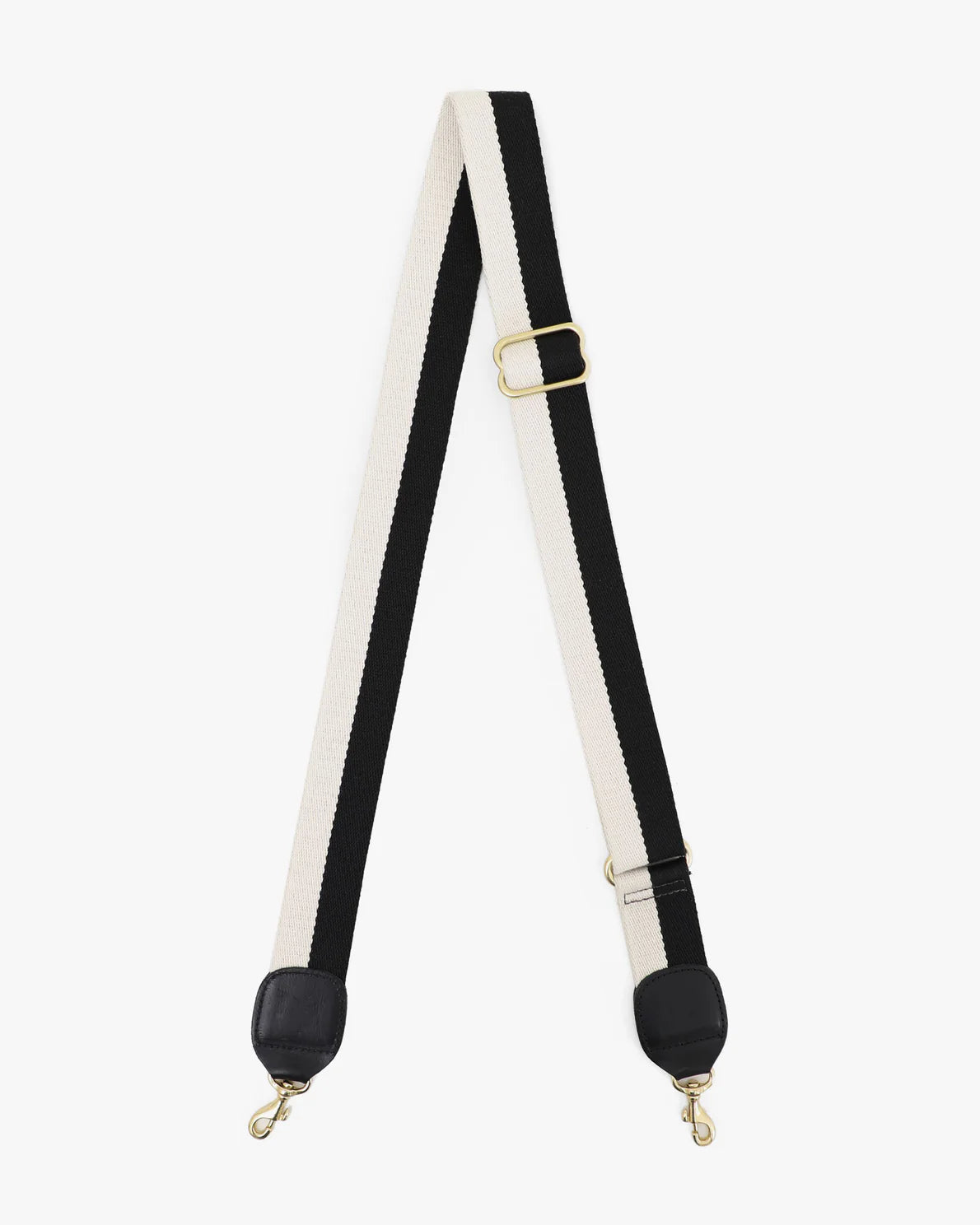 A black and white striped shoulder strap made from durable nylon webbing, featuring gold metal clasps at both ends and an adjustable gold buckle in the middle. Perfect for a crossbody bag or shoulder bag, the Crossbody Strap from Clare Vivier is laid flat on a white background.