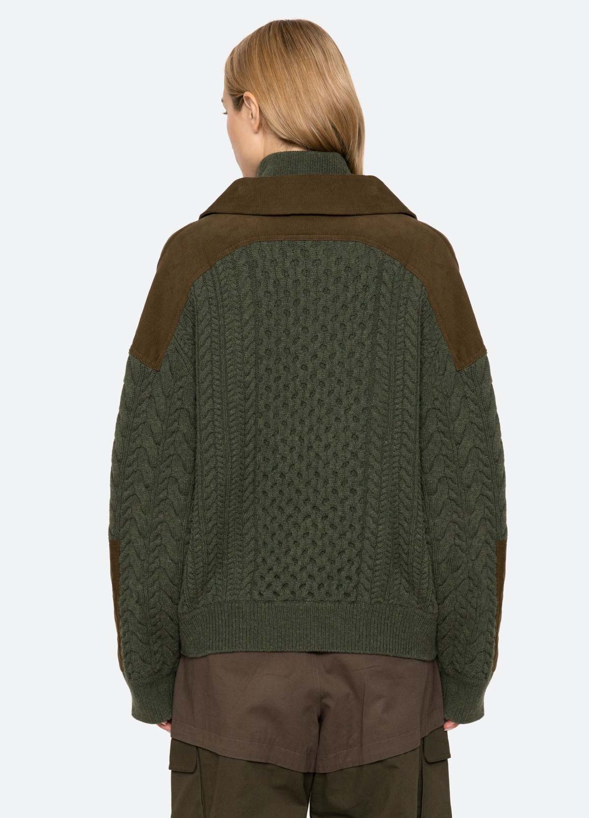 Green Allen Cable Half Zip Sweater by Sea New York, shown from the back, paired with brown pants.