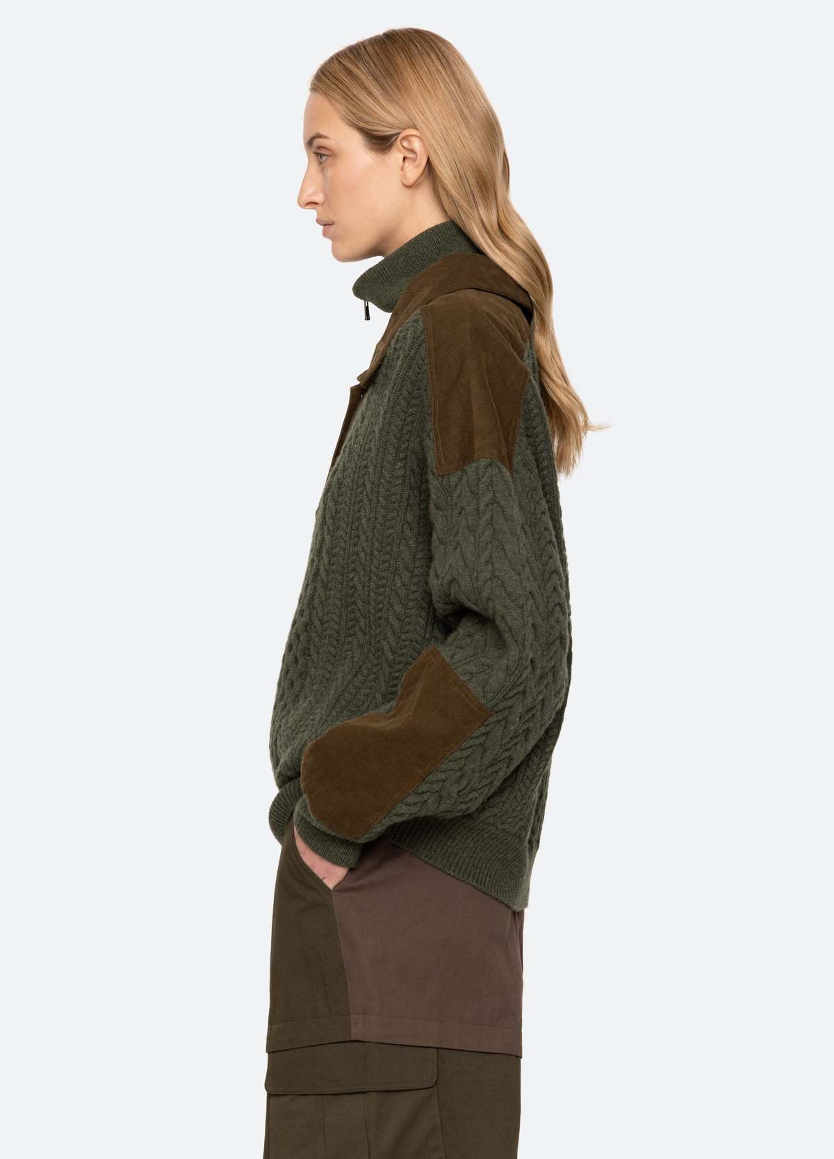 Green Sea New York Allen Cable Half Zip Sweater on model, cable knit detail, profile view against light background.