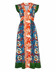 The April Dress from Hunter Bell NYC features a V-neckline, sleeveless design, and vibrant vertical panels. It boasts bold orange grove mixed print patterns in orange, blue, green, with red fruit and leaf motifs for an eye-catching look.